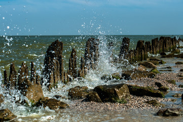 A sea wave with many drops in the sunny summer day