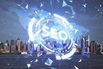 SEO hologram on city view with skyscrapers background double exposure. Search optimization concept.