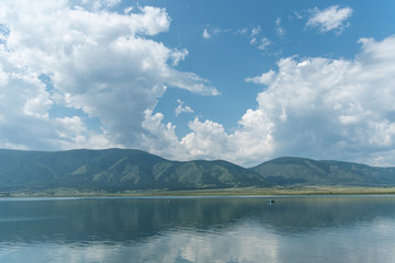 Beautiful summer lanscape, blue cloudy sky, mountains and river