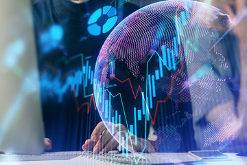 Forex graph with businessman typing on computer in office on background. Concept of analysis....