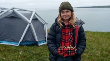Young woman holds wild mushrooms in hands