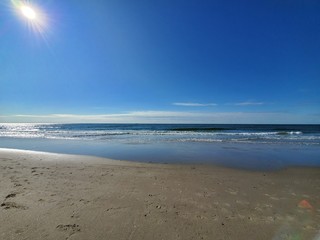 City Beach, Rockaway beach, New York  at sunrise, quiet and empty with a peaceful glow in the background.