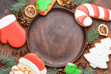 Plate with tasty Christmas cookies on color background