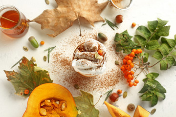 Composition with tasty pumpkin coffee on white background