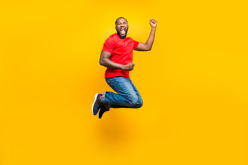 Fototapeta na wymiar Full length body size photo of rejoicing overjoyed cheerful man who won some competitions at running while isolated with yellow background