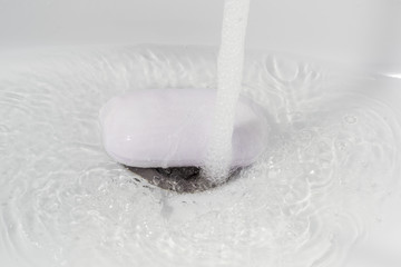 washing hands with soap on a white sink background, children's hands