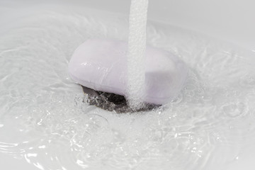washing hands with soap on a white sink background, children's hands