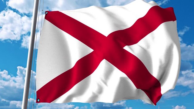 Waving flag of Alabama against clouds