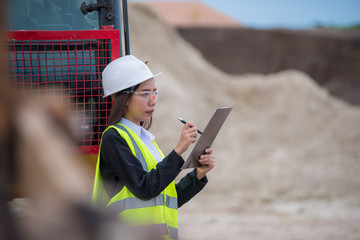 Asian engineer working at site of a large building project,Thailand people,Work overtime at construction site