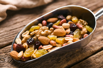Healthy trail mix snack made of nuts (walnut, almond, peanut) and dried fruits (raisin, sultana) on...