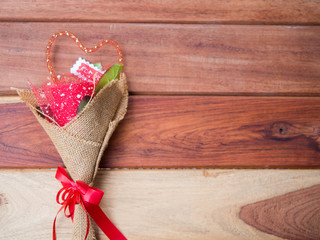 Close up red rose color put on the wood gift for girlfriend holiday romance background, top view