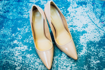 Beige shoes on blue background