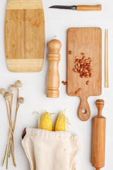 Composition of wooden cutting boards and wooden utensils and kitchen utensils. Top view.