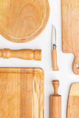 Composition of wooden cutting boards and wooden utensils and kitchen utensils. Top view.