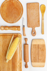 Composition of wooden cutting boards and wooden utensils and kitchen utensils. Top view.