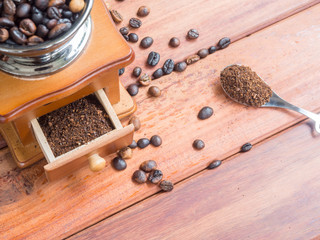 Close up coffee beans organic in wooden grinder homemade on wood table background, top view Coffee powder
