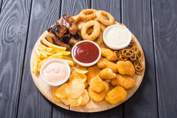 Onion rings , nuggets grilled wings , french fries and mix of snacks