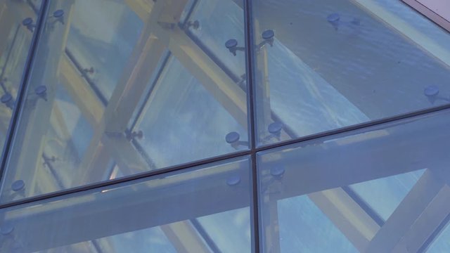 Glass Curtain Facade Wall. Fasteners Elements of Spider Glass System. Facade Detail. Architecture Abstract Background. Showcase of a Modern Building Tilt Up