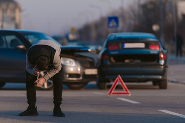 Sad man after car crashing