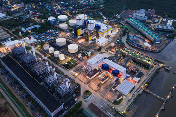 Aerial View of Electric plants generator from gas and oil send power line to town with cooling system with cooling system