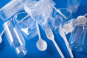 single use plastic bottles, cups, forks, spoons. concept of recycling plastic, plastic waste
