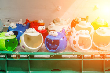 Scented lamps for Spa in the form of colorful fish in the shop window on the street.