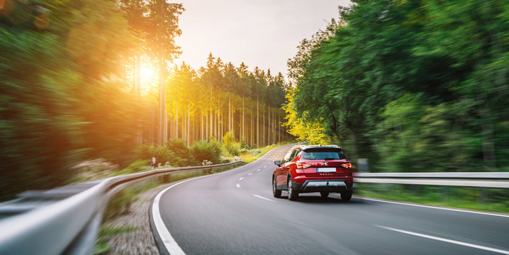 Aachen, Germany - August 26, 2019: Seat Arona small SUV car in european mountain landscape road at sunset