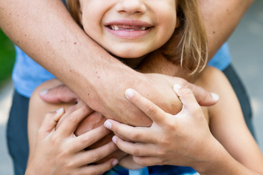 Daughter Smiles in Father's Arms