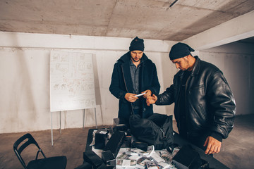 Criminals counting stolen cash