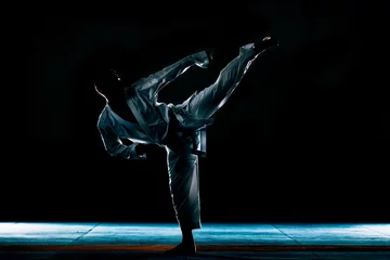 Rolgordijnen Martial arts master on fight training in gym © qunica.com