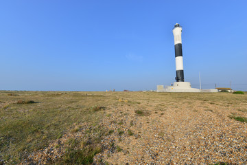 Fototapeta na wymiar Modern lighthouse at Dungeness in summertime.