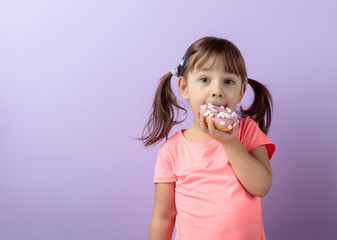 Four-year-old girl eat donut.