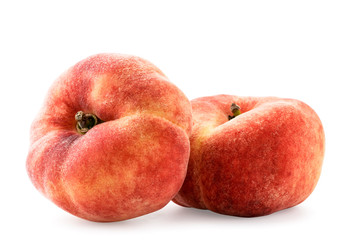 Two flat peaches on a white background, isolated.