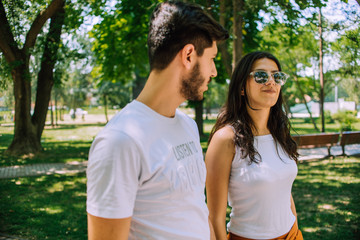 Fototapeta premium Amorous man and woman spending leisure in summer park