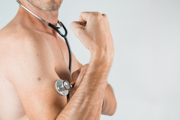 Fototapeta premium shirtless men with stethoscope on the arm