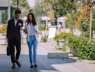 Business people discussing about job while walking together in downtown