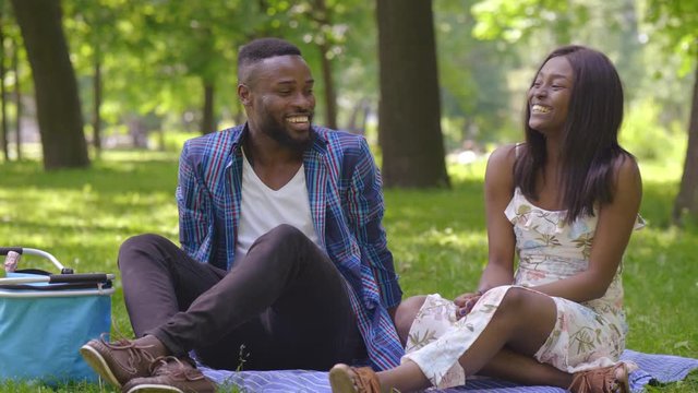 Picture of happy romantic couple having picnic