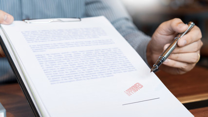 male point to signing business document for putting signature, fountain pen and approved stamped on a document, certificate contract agreement lawyer hand concept.