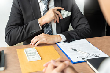 Bribery and corruption, Businessman hand giving money and receive in the envelope offered file Dishonest cheating in business illegal money concept.