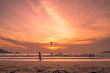 Naklejka na ściany i meble Sunset lovers, bright orange sky, on the beach Famous Phuket Patong Thailand