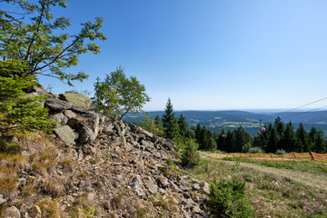 Fototapeta na wymiar Beautiful scenic view into the landscape with rocks and stones from the top of the Ochsenkopf mountain in the Fichtel mountains in Germany into the southern direction