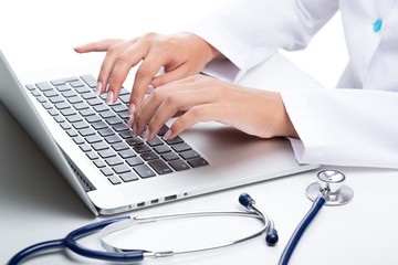 Closeup of Doctor Typing on Laptop