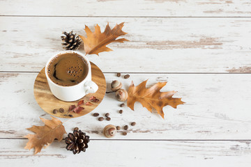 Cup of black coffee in autumn background. Copy space.