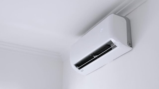 Flat air conditioner on white wall in room. Closeup