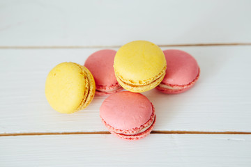 Sweet colorful French macaroon cookies dessert on white wooden table
