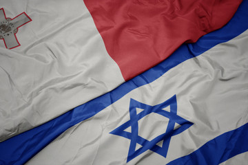waving colorful flag of israel and national flag of malta