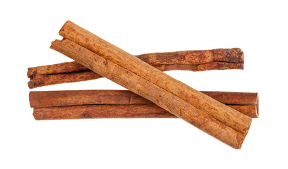 three rolled dried Cinnamon sticks isolated