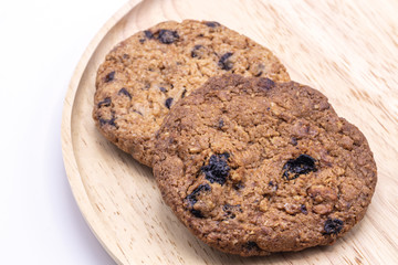 Tasty Chocolate chip cookies on wooden plate background.