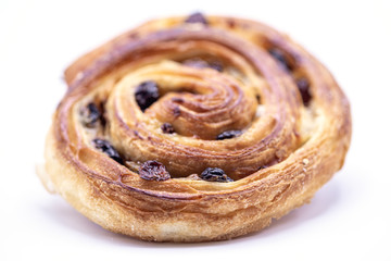Raisin Danish pastry on wooden plate background.