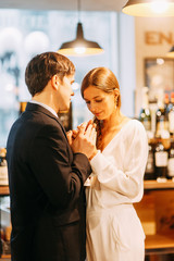  bright emotions in a family photo shoot. happy couple in the interior of a wine bar.